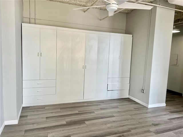 unfurnished bedroom featuring wood finished floors and baseboards
