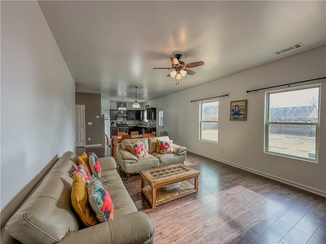 living room featuring dark hardwood / wood-style floors and ceiling fan