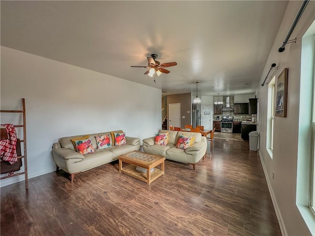 living room with dark wood-type flooring and ceiling fan