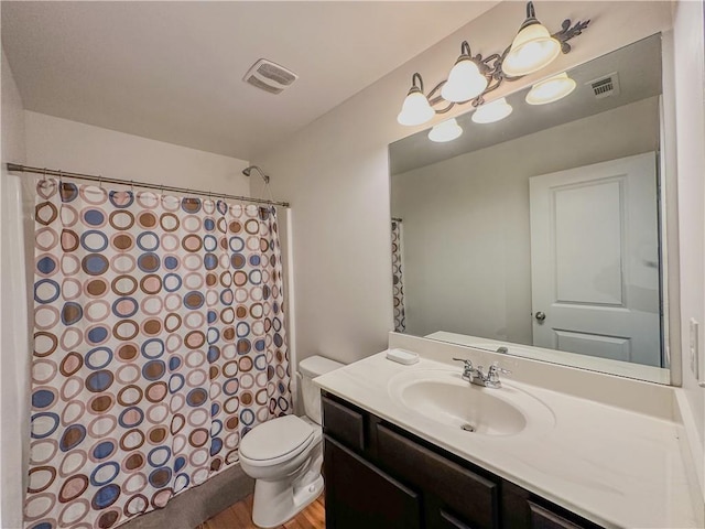 bathroom with vanity, toilet, curtained shower, and hardwood / wood-style floors