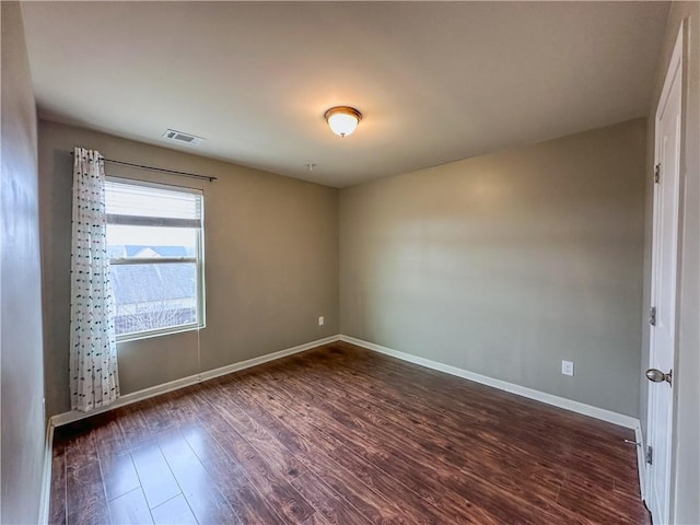 empty room with dark hardwood / wood-style flooring