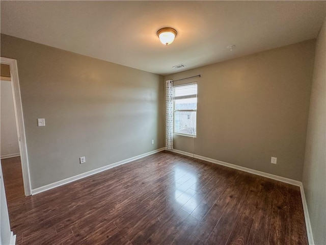 spare room with dark hardwood / wood-style flooring