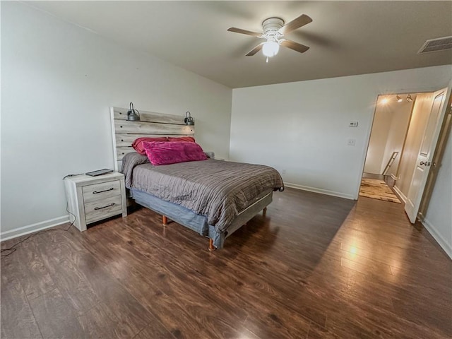 bedroom with dark hardwood / wood-style flooring and ceiling fan