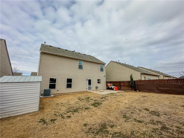 back of property with a patio, a yard, cooling unit, and a storage shed