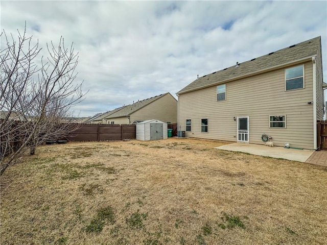 back of property with cooling unit, a yard, a shed, and a patio area