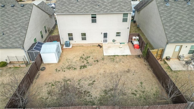 rear view of house featuring a shed, a patio area, and central air condition unit