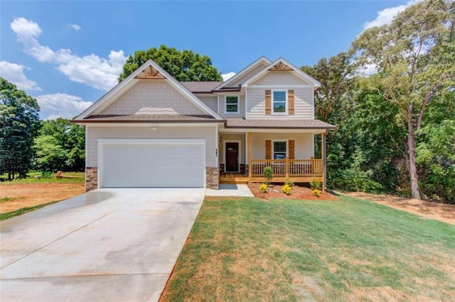 craftsman-style house with a front yard, a porch, and a garage