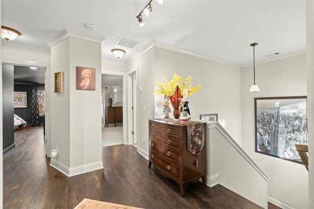 hall featuring ornamental molding, dark wood-type flooring, and rail lighting