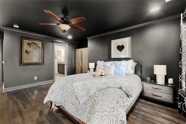 bedroom featuring crown molding, ceiling fan, dark hardwood / wood-style floors, and connected bathroom