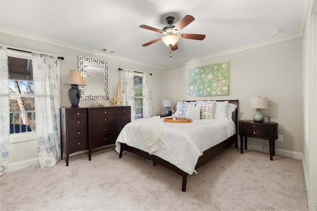 carpeted bedroom with ornamental molding and ceiling fan