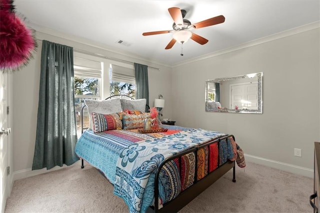 carpeted bedroom with ceiling fan and crown molding