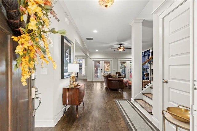 entryway featuring ceiling fan, dark wood-type flooring, french doors, ornamental molding, and decorative columns