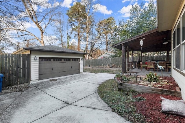 view of yard with an outbuilding, a garage, and a patio area