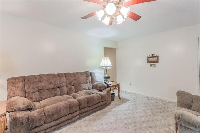 carpeted living room featuring ceiling fan