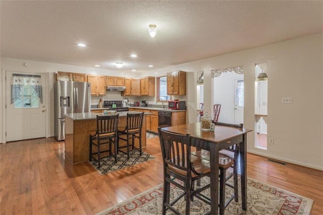 dining room with light wood-type flooring and sink