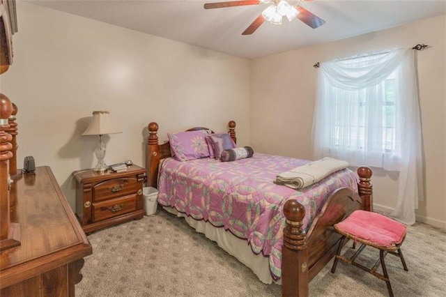 bedroom with ceiling fan and light carpet