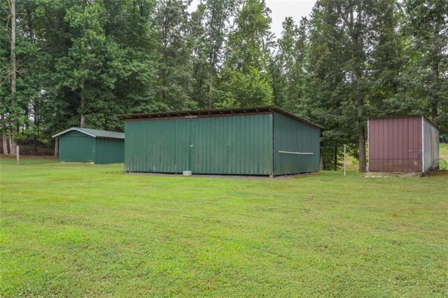 view of outbuilding featuring a lawn