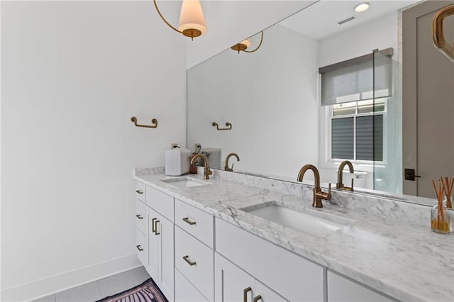 bathroom featuring tile patterned floors, double vanity, and a sink