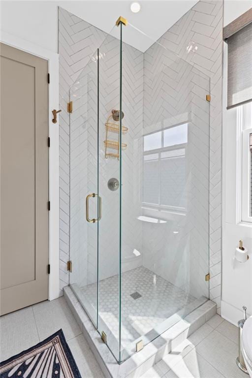 full bath with tile patterned floors and a shower stall