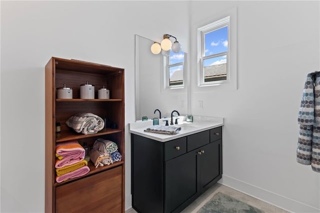 bathroom with baseboards and vanity