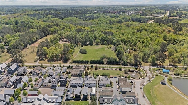 bird's eye view featuring a forest view and a residential view