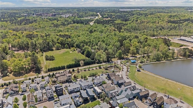 drone / aerial view featuring a water view and a view of trees