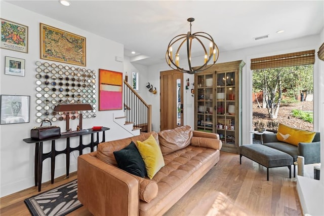 living room with a chandelier, recessed lighting, stairs, visible vents, and wood finished floors