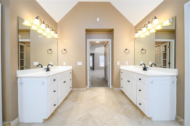 bathroom featuring vanity and lofted ceiling