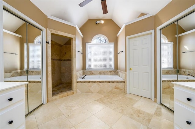 bathroom with ceiling fan, vanity, lofted ceiling, and shower with separate bathtub