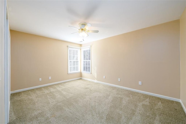 spare room featuring ceiling fan and light colored carpet