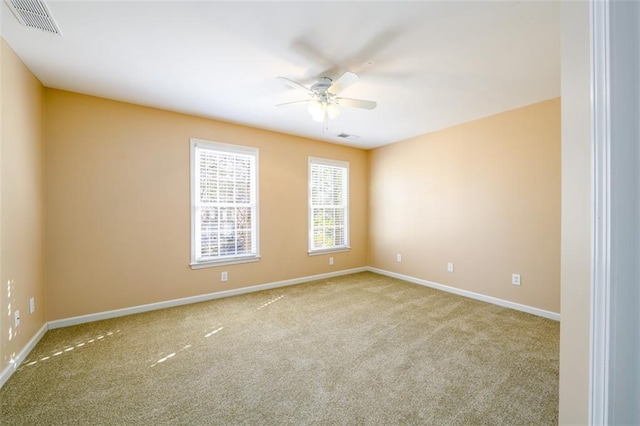 unfurnished room with ceiling fan and light colored carpet