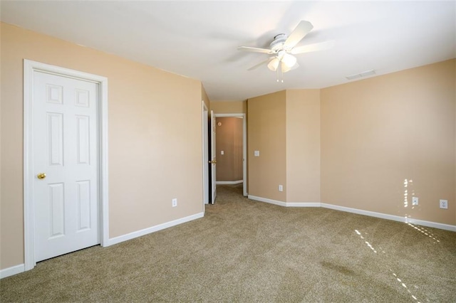 empty room featuring carpet flooring and ceiling fan