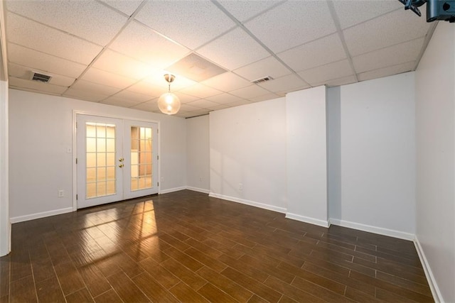 spare room with a drop ceiling and french doors