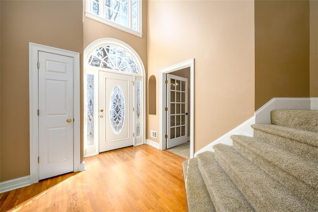 entrance foyer featuring hardwood / wood-style flooring and a high ceiling