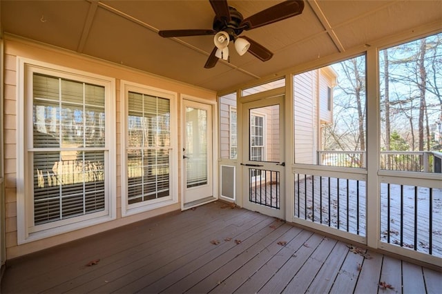 unfurnished sunroom featuring ceiling fan