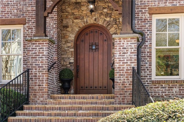 property entrance featuring brick siding