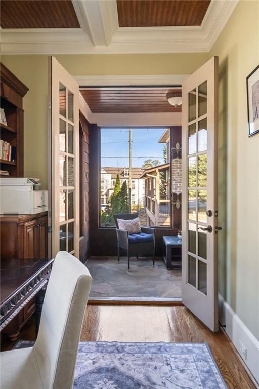 doorway featuring ornamental molding, wood finished floors, and french doors