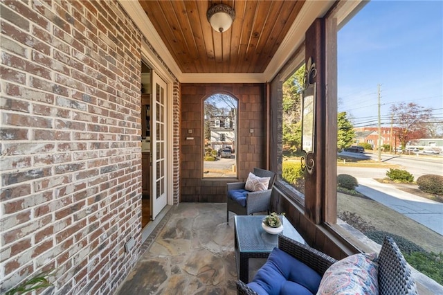 sunroom featuring wooden ceiling