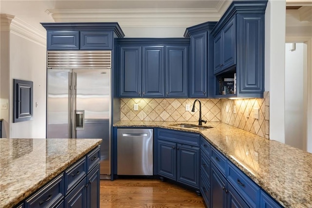 kitchen with blue cabinets and appliances with stainless steel finishes