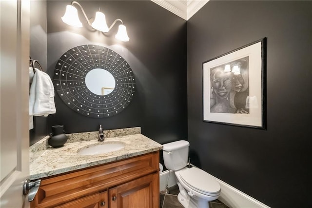 bathroom featuring vanity, toilet, and baseboards