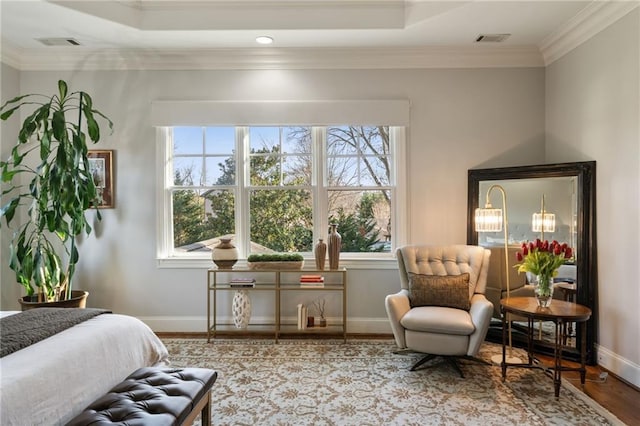 bedroom with baseboards, wood finished floors, visible vents, and crown molding