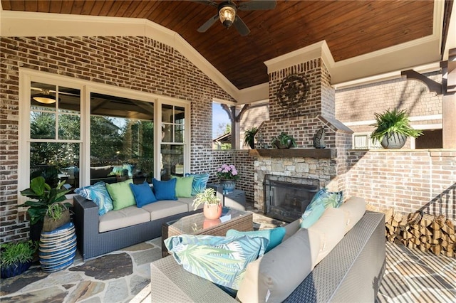 view of patio with a ceiling fan and an outdoor living space with a fireplace