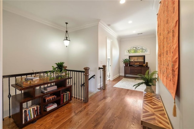 hallway featuring recessed lighting, wood finished floors, an upstairs landing, and crown molding