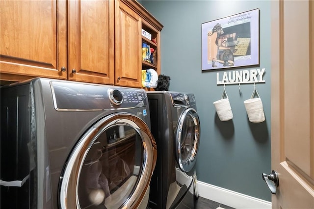 laundry room featuring cabinet space, independent washer and dryer, and baseboards