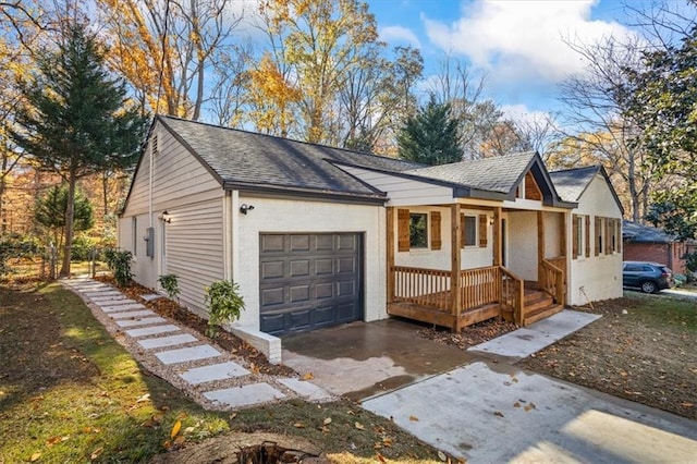 view of home's exterior with an attached garage, covered porch, driveway, and a shingled roof