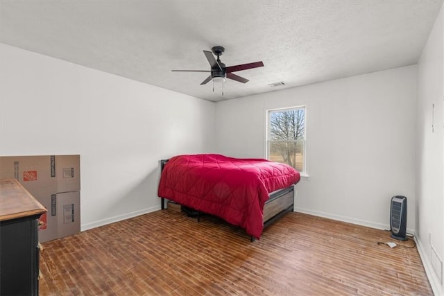 bedroom with ceiling fan and wood-type flooring