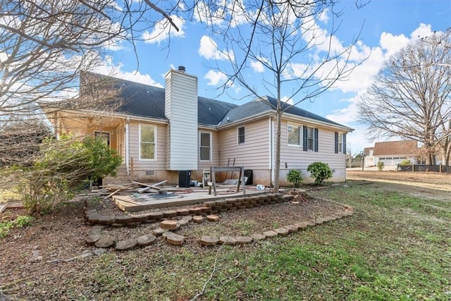 rear view of property featuring a patio area and a lawn