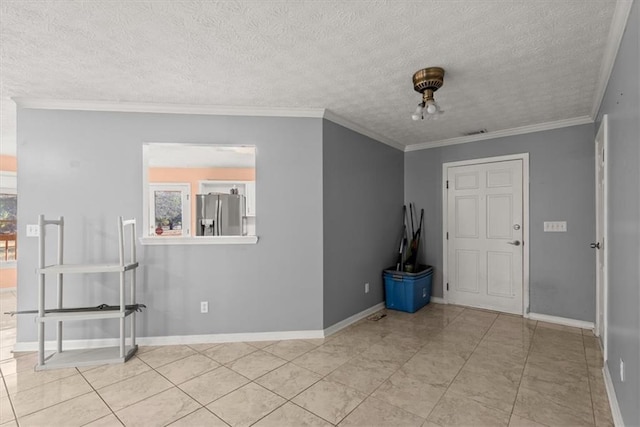 foyer featuring a textured ceiling, light tile patterned flooring, and crown molding