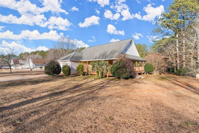 view of side of home with a lawn