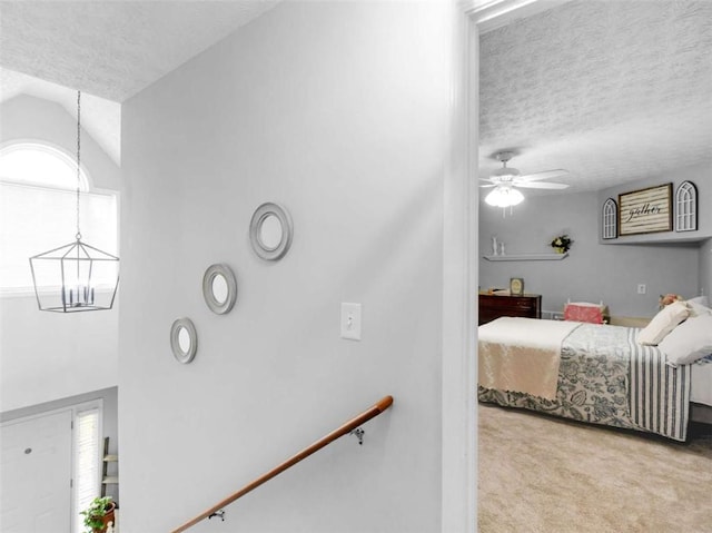 bedroom featuring a textured ceiling, carpet, and a chandelier